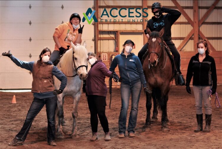 Volunteers With Students Riding Horses