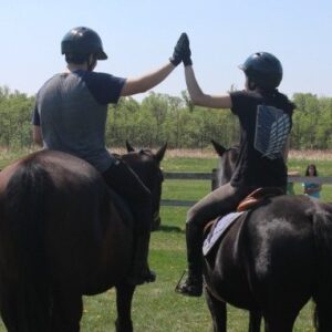 Students on horses-high-five